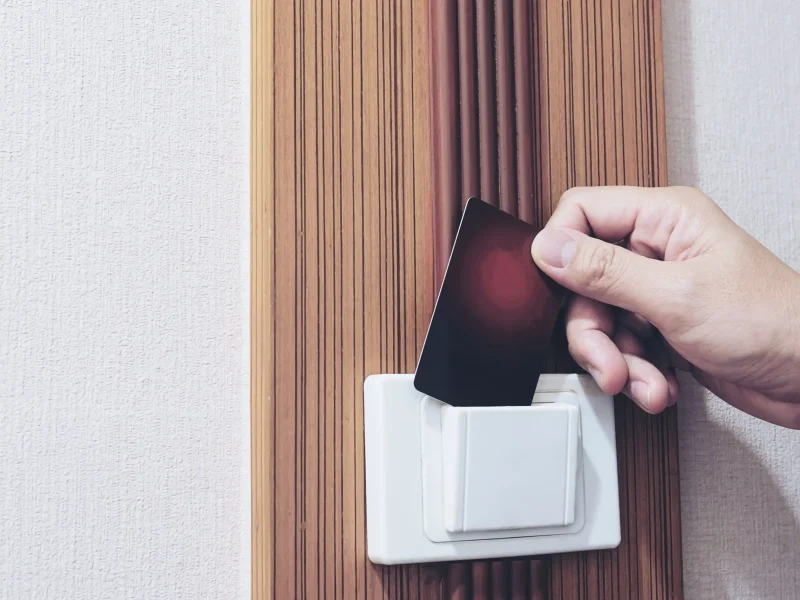 man-putting-key-card-switch-hotel-room_11zon